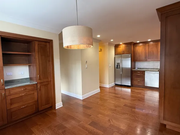 a view of a kitchen with a refrigerator and a sink