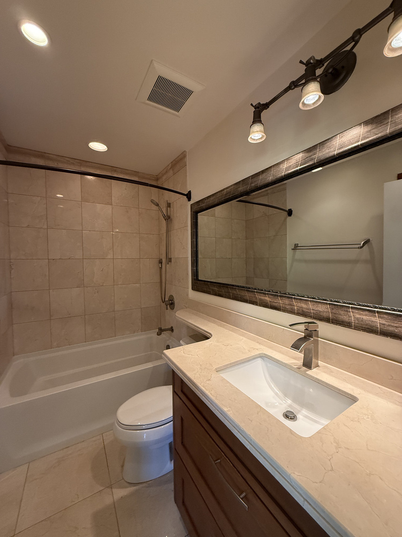 60 South Dee Road, Unit G Park Ridge, IL 60068 - Photo 16 of 23 a bathroom with a sink a toilet and shower