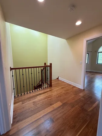 a view of a room with wooden floor