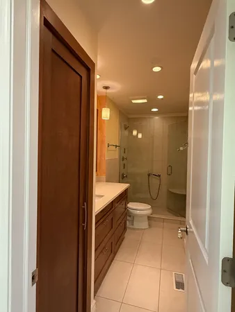 a bathroom with a sink a toilet and shower