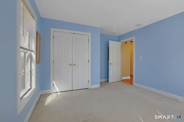 a bathroom with a double vanity sink toilet and a mirror