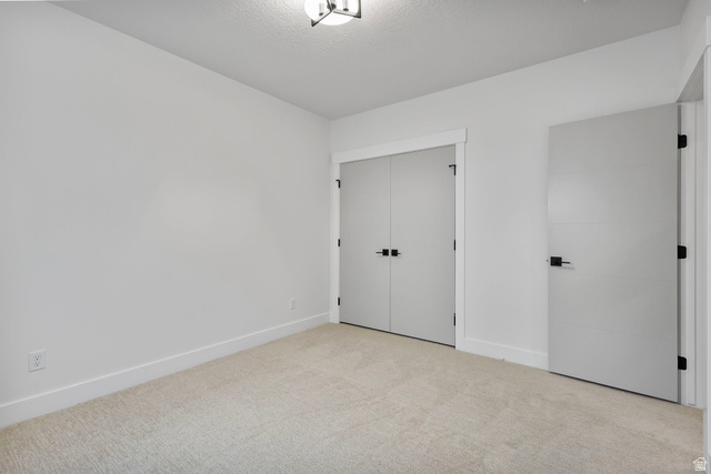 710 East Mountain Road North Ogden, UT 84414 - Photo 30 of 36 Room featuring light neutral-toned carpeting, white walls, and a modern ceiling light fixture