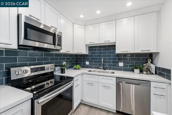 a kitchen with a sink stove and cabinets