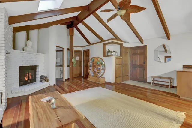 a living room with furniture a rug and a large window