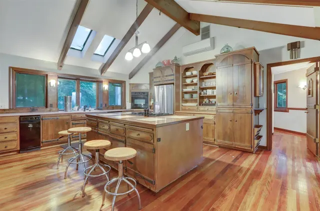 a living room with furniture a flat screen tv and a large window