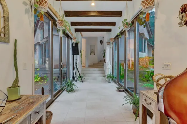 a spacious bedroom with a bed and a chandelier