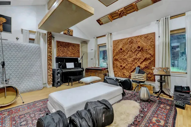 a spacious bedroom with a bed and a fireplace