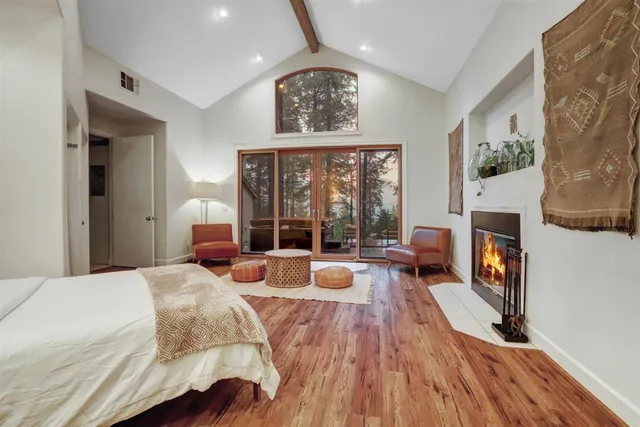 a view of a house with backyard and a tree