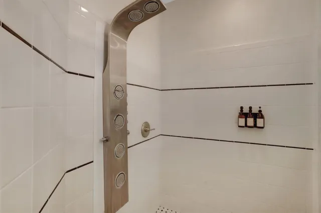 a front view of a house with a yard and potted plants