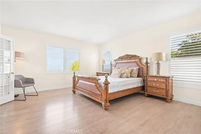 a spacious bedroom with a bed and cabinet