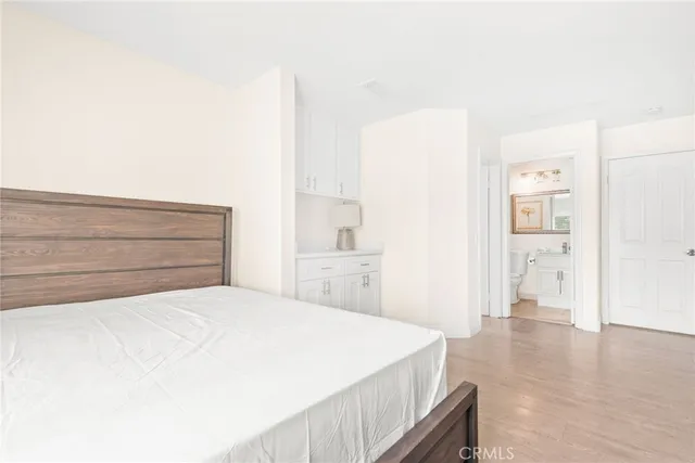 a bathroom with a toilet sink vanity and mirror