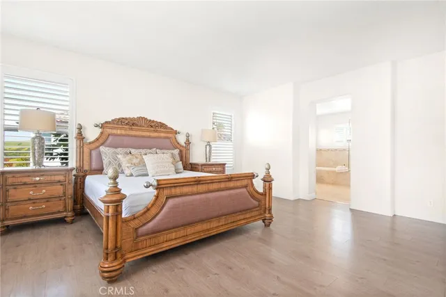 a spacious bedroom with a bed and a chair