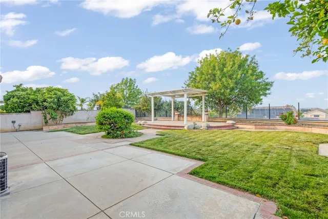 a front view of a house with a yard and outdoor seating