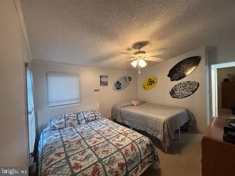 a bedroom with two beds and a chandelier