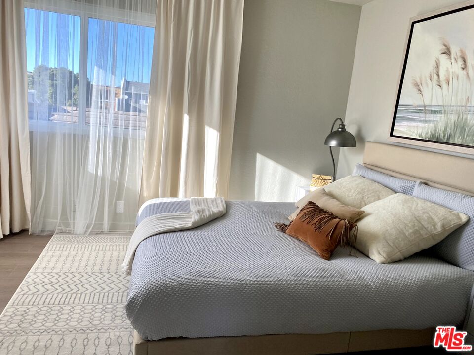 4510 Gateshead Bay Oxnard, CA 93035 - Photo 16 of 36 a bedroom with a bed and wooden floor