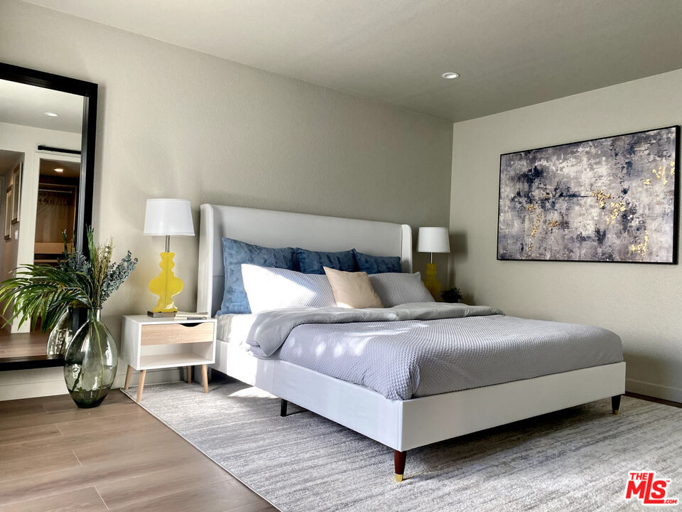 4510 Gateshead Bay Oxnard, CA 93035 - Photo 29 of 36 a bedroom with a bed a couch and potted plant on the dresser