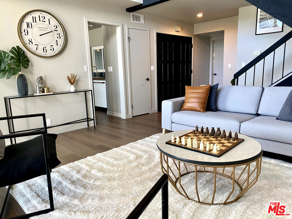4510 Gateshead Bay Oxnard, CA 93035 - Photo 3 of 36 a living room with furniture a clock on wall and a table