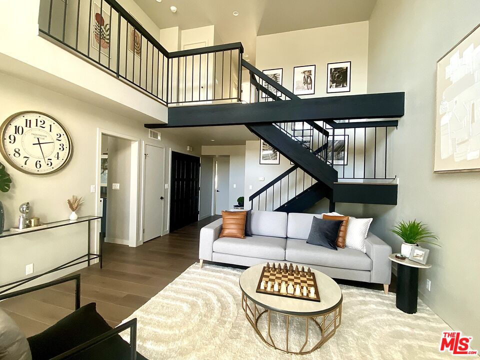 4510 Gateshead Bay Oxnard, CA 93035 - Photo 5 of 36 a living room with furniture a clock and a window