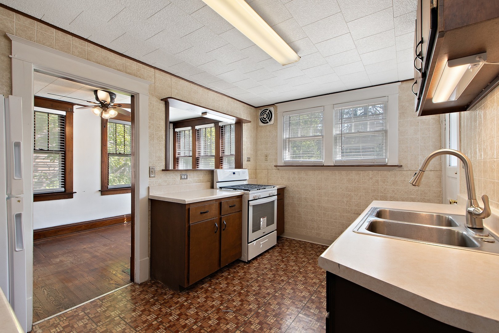 1525 Burr Oak Road Homewood, IL 60430 - Photo 11 of 20 a kitchen with a stove a sink and a refrigerator