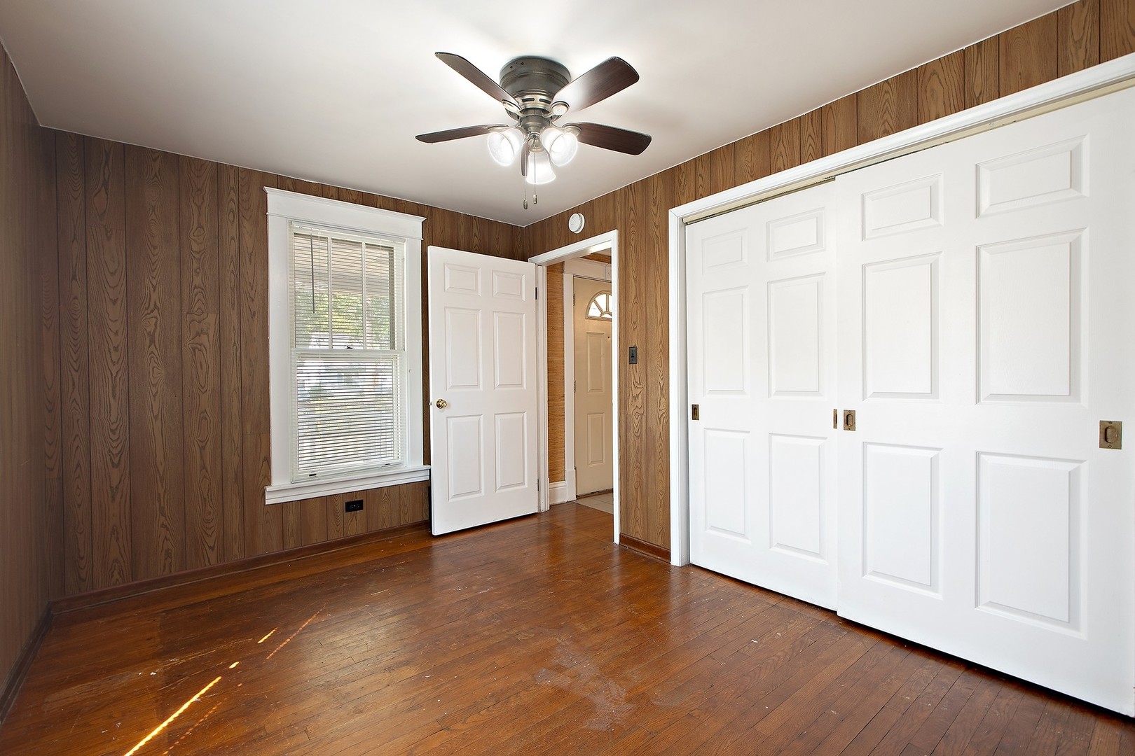 1525 Burr Oak Road Homewood, IL 60430 - Photo 12 of 20 an empty room with wooden floor and ceiling fan