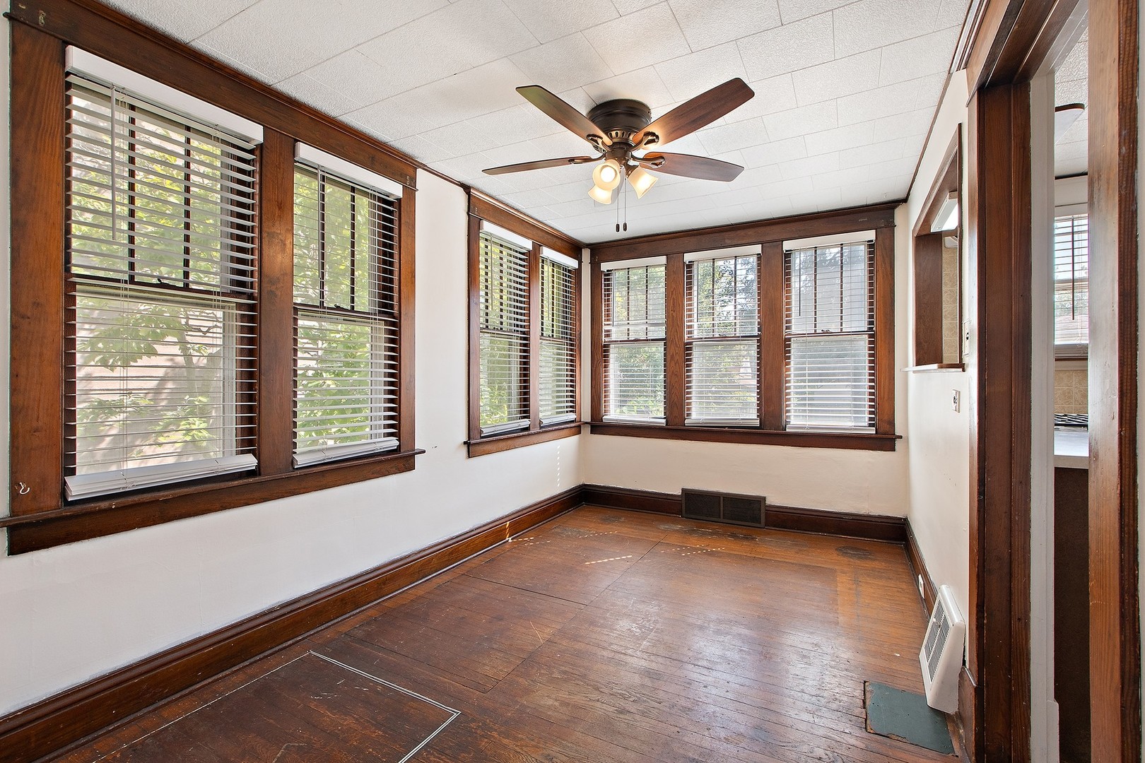 1525 Burr Oak Road Homewood, IL 60430 - Photo 7 of 20 a view of an empty room with a window and wooden floor