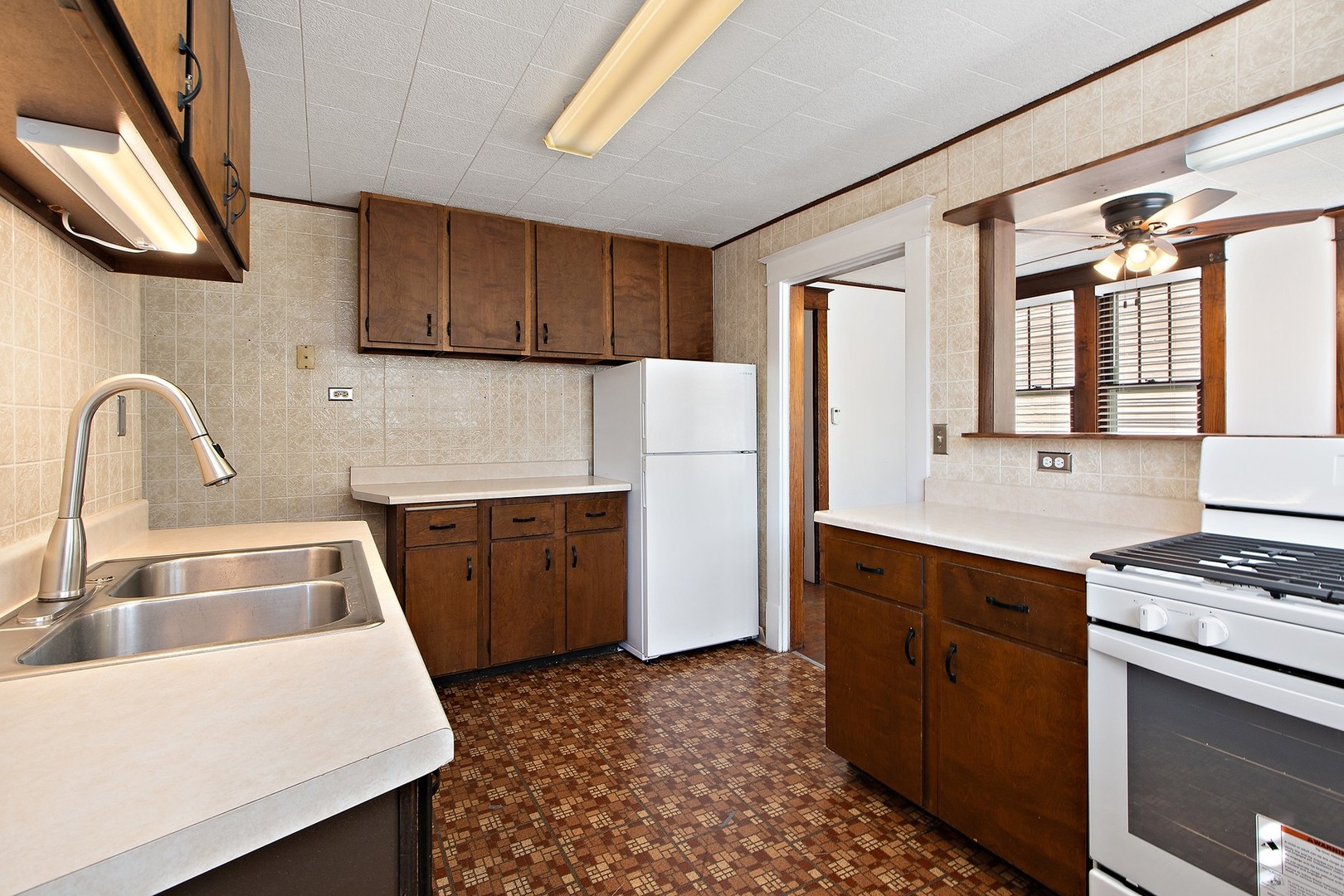1525 Burr Oak Road Homewood, IL 60430 - Photo 10 of 20 a kitchen with sink a refrigerator and a stove
