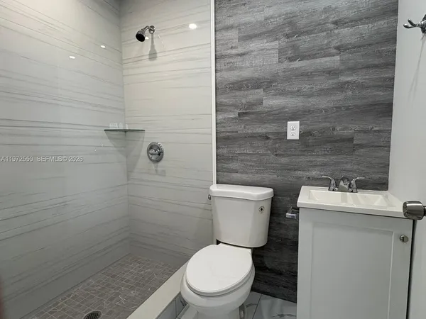 a white toilet sitting next to a bathroom sink