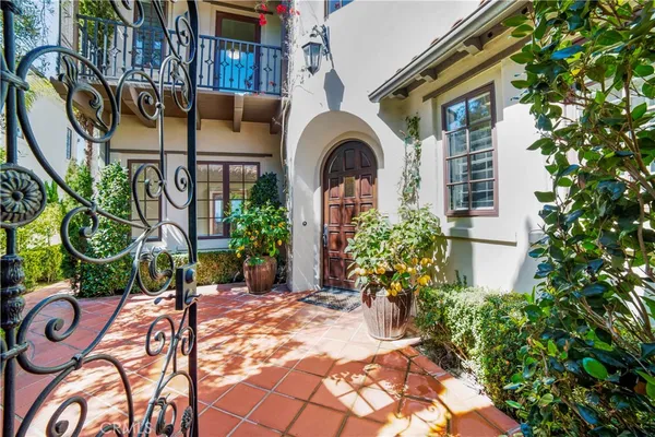 a view of a hallway with white walls and chandelier