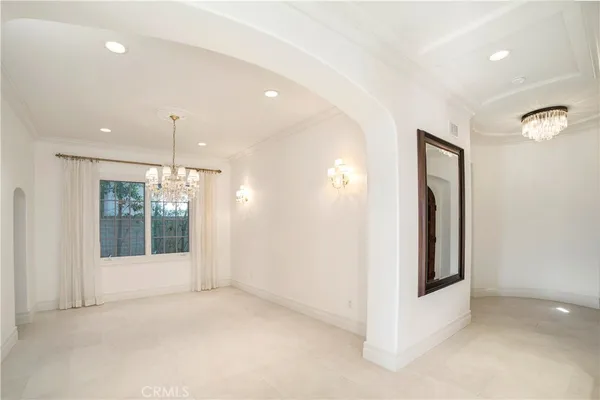 a large white kitchen with a large window