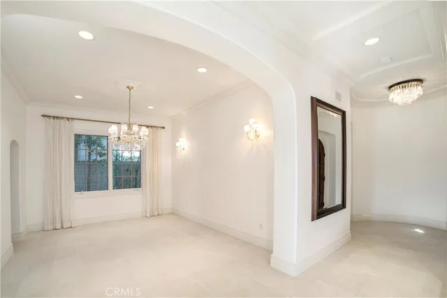 a large white kitchen with a large window