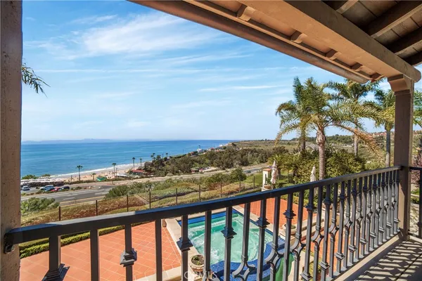 a bathroom with a double vanity sink a large mirror and a bathtub