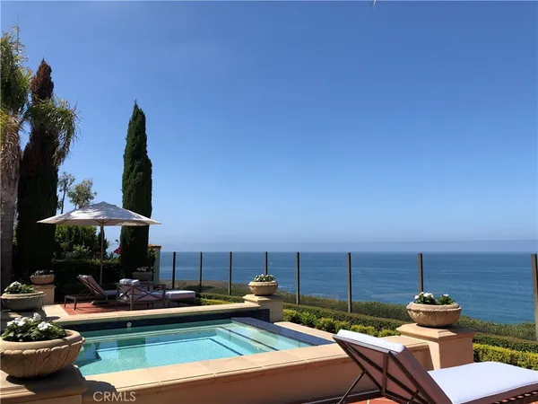a view of a swimming pool with chairs in patio