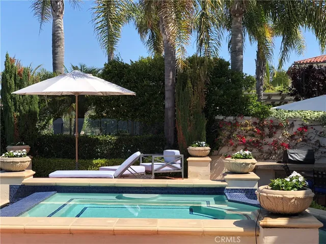 a view of an outdoor space with furniture and umbrella