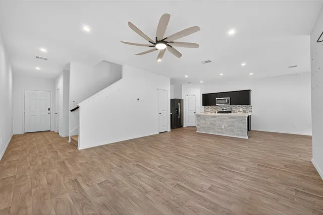 a view of kitchen with sink and refrigerator