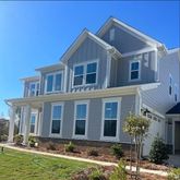 a front view of a house with yard and green space