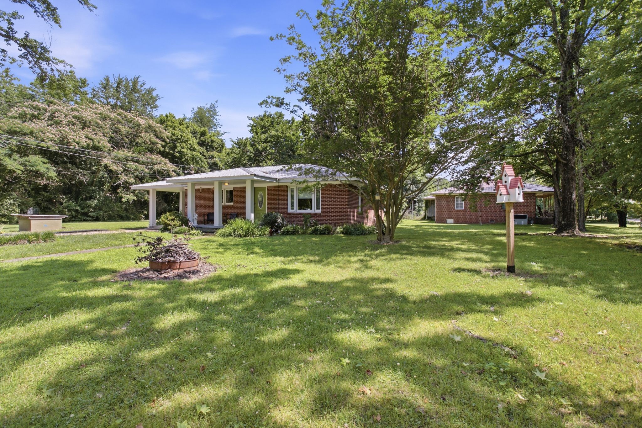 150 Toms Creek Road Linden, TN 37096 - Photo 14 of 23 a view of a house with a backyard porch and sitting area