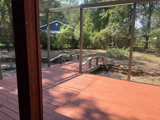 a view of a yard with wooden floor