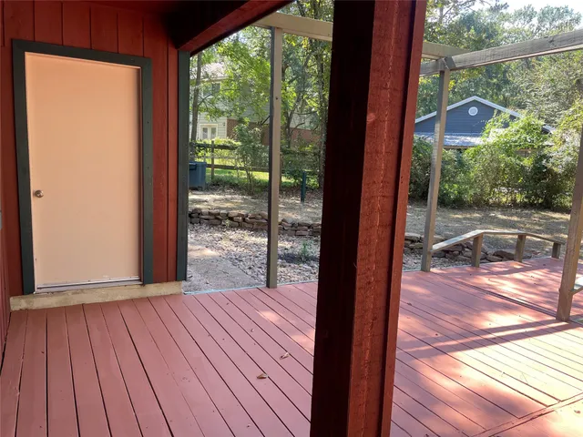 a view of a yard with wooden fence