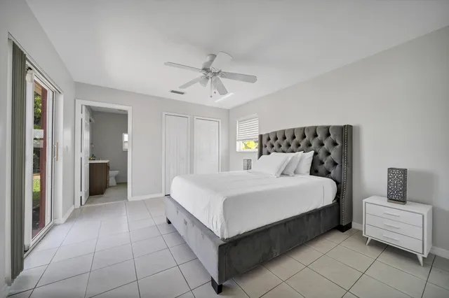 a spacious bedroom with a bed and a chandelier