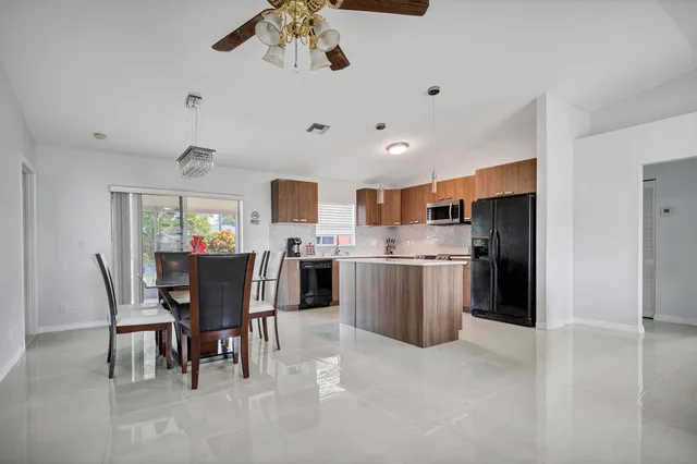 a view of a dining room with furniture and a kitchen
