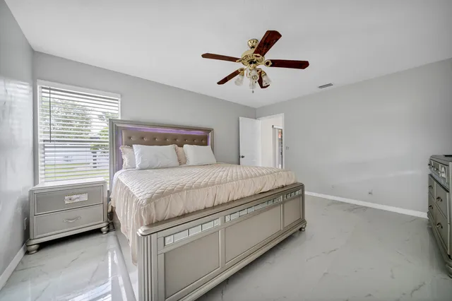 a bedroom with a bed and a window