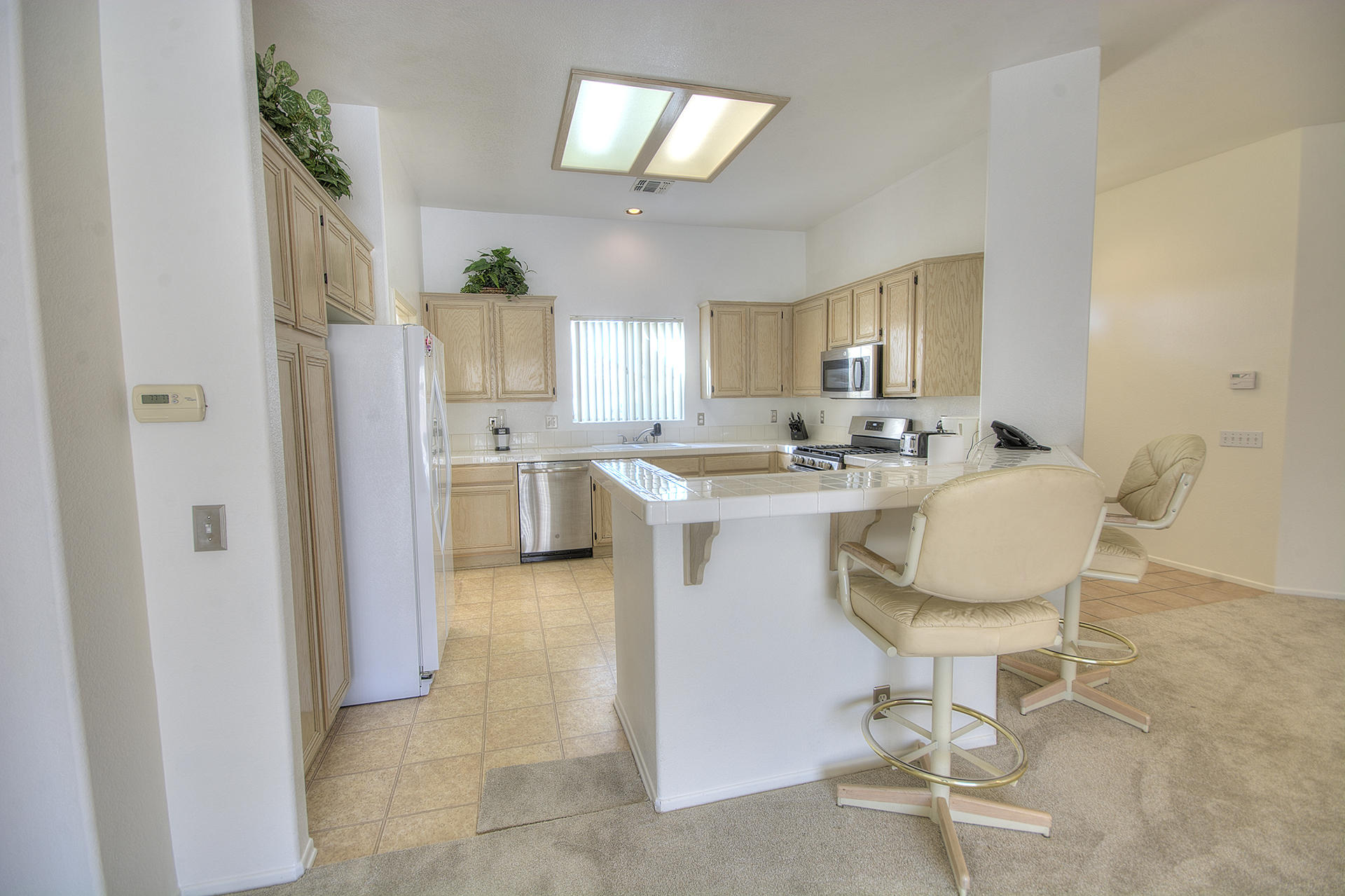 68392 Riviera Road Cathedral City, CA 92234 - Photo 7 of 21 a living room with stainless steel appliances kitchen island granite countertop furniture and a dining table