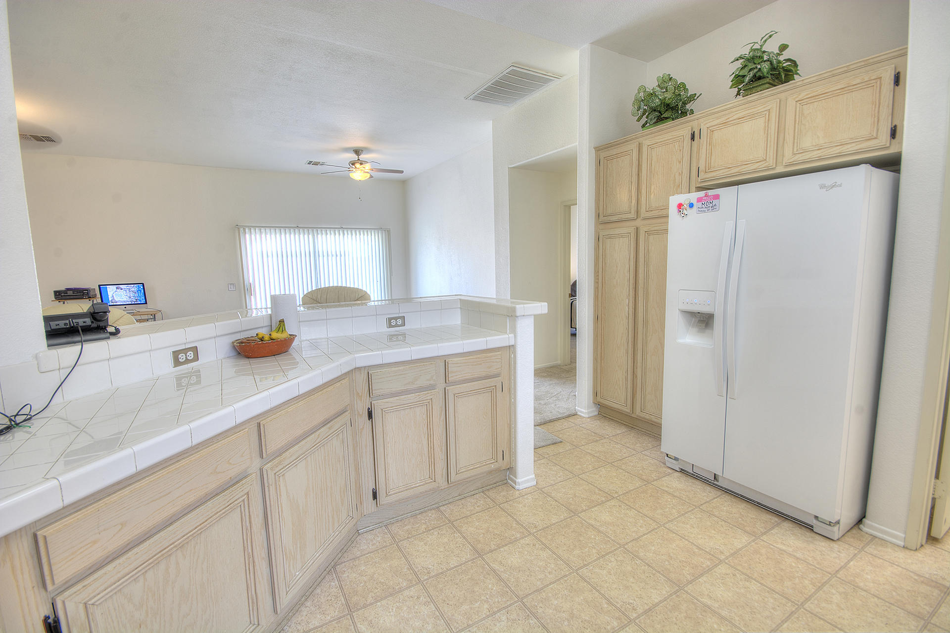 68392 Riviera Road Cathedral City, CA 92234 - Photo 9 of 21 a kitchen with white cabinets and refrigerator