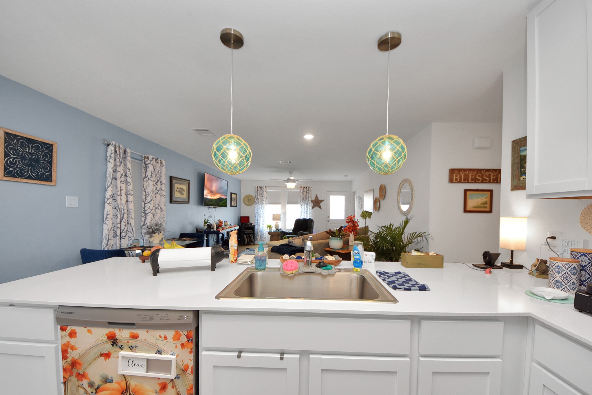 1719 Windrose Bend Angleton, TX 77515 - Photo 14 of 31 a room with kitchen island a clock and a view of living room
