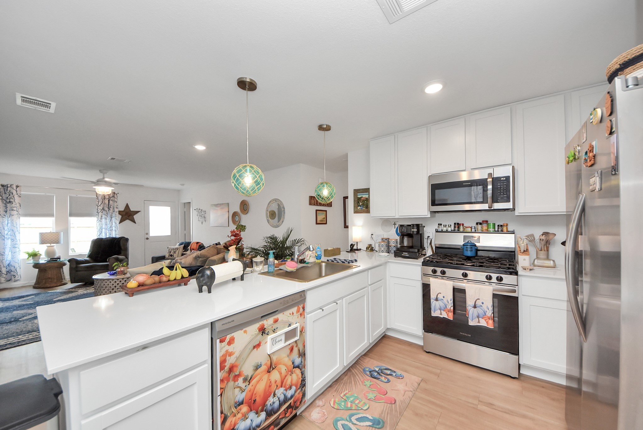 1719 Windrose Bend Angleton, TX 77515 - Photo 15 of 31 a kitchen with a sink stainless steel appliances and white cabinets
