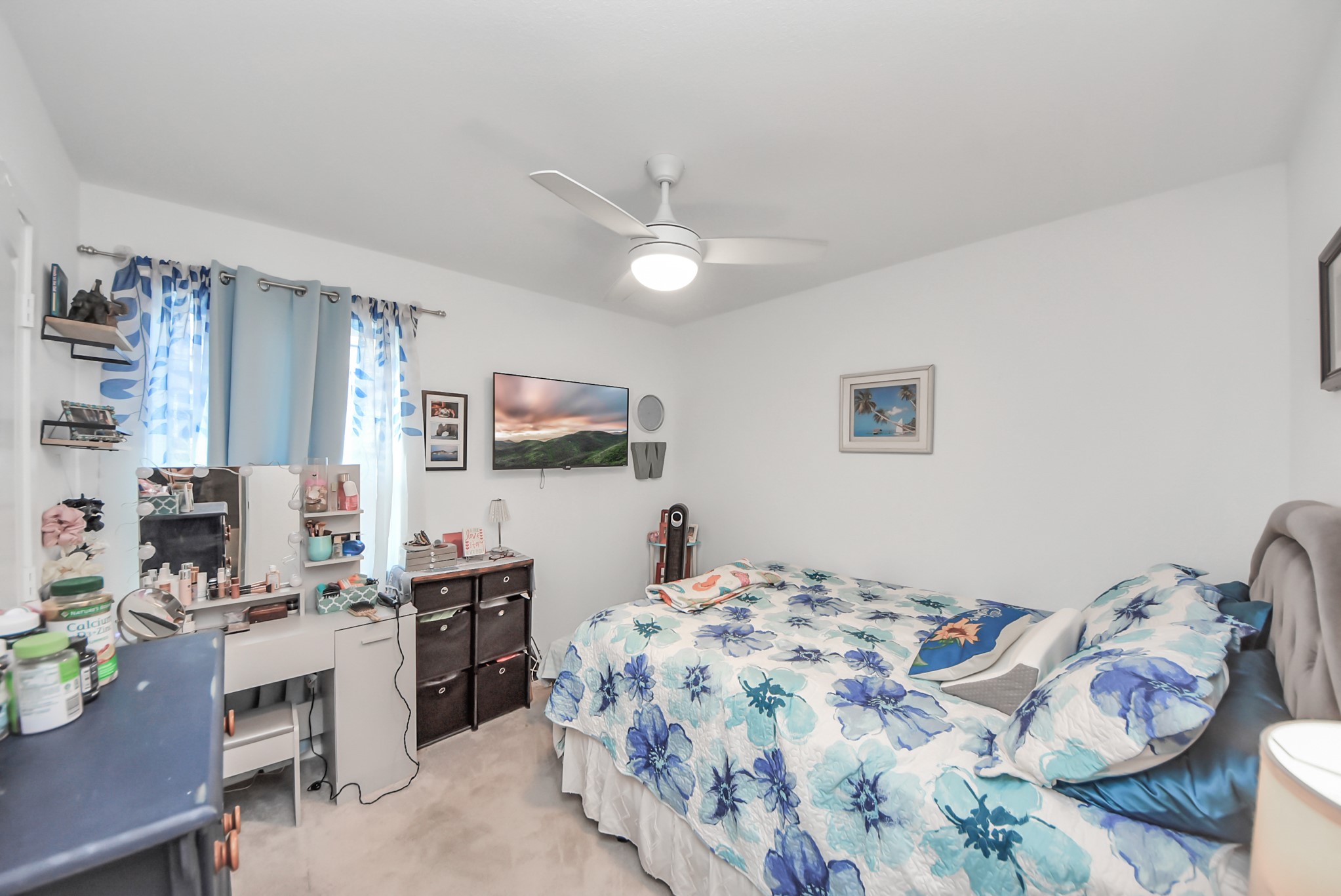 1719 Windrose Bend Angleton, TX 77515 - Photo 17 of 31 a bedroom that has a bed and a chandelier