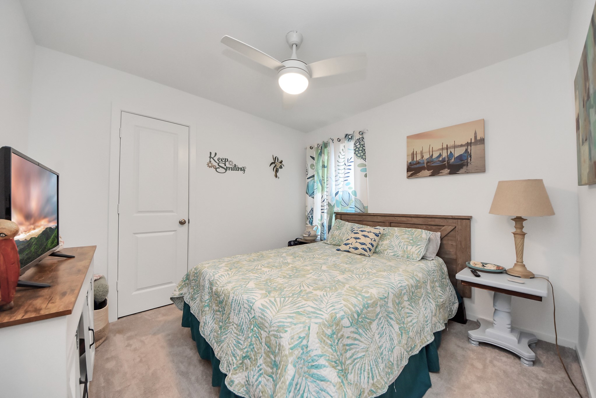 1719 Windrose Bend Angleton, TX 77515 - Photo 18 of 31 a bedroom with a bed and a flat screen tv