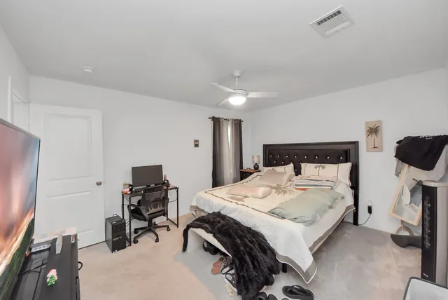 a bedroom with a bed and a desk