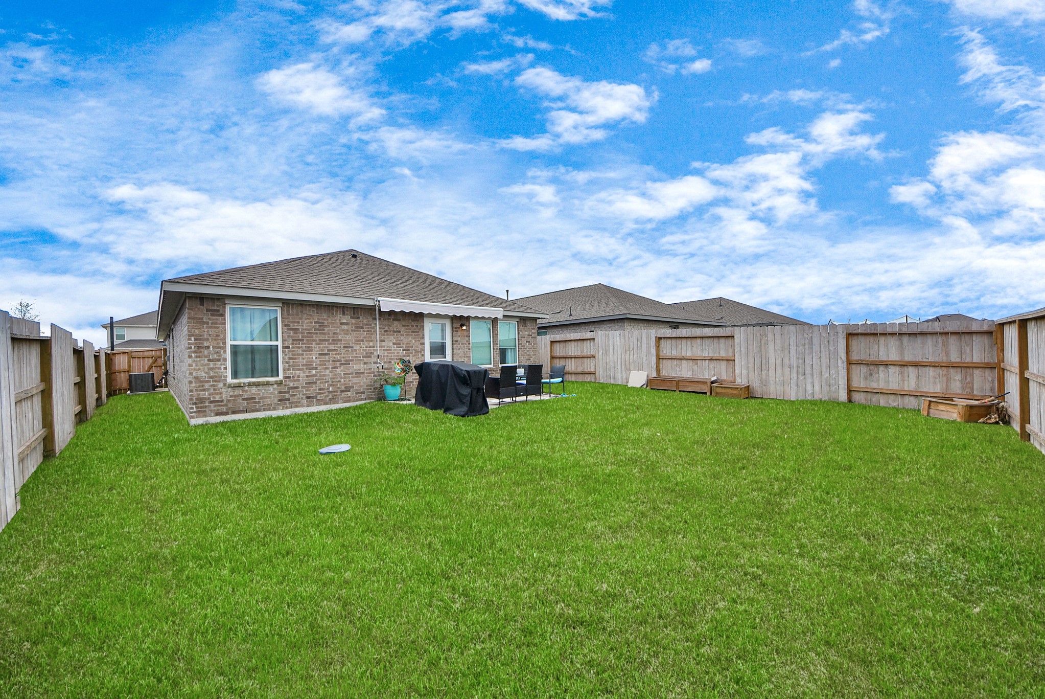 1719 Windrose Bend Angleton, TX 77515 - Photo 26 of 31 a view of a house with backyard and garden