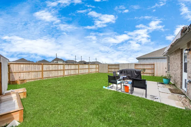 a view of a backyard with sitting area